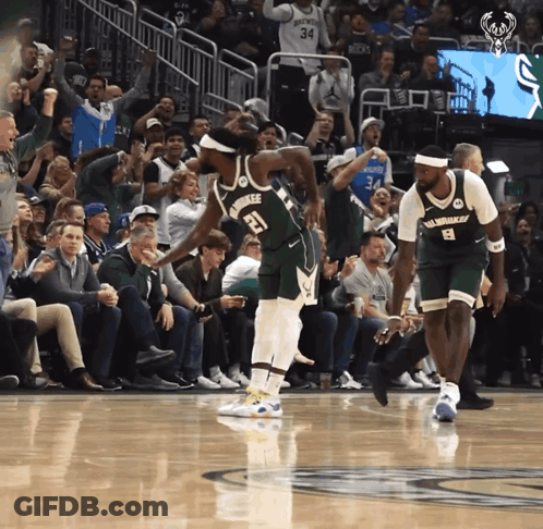 A Basketball Player With The Number 21 On His Jersey Stands On The Court GIF