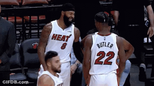A Basketball Player With The Number 22 On His Back Talks To Another Player GIF