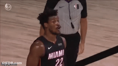 A Basketball Player With The Number 22 On His Jersey Is Standing On The Court . GIF