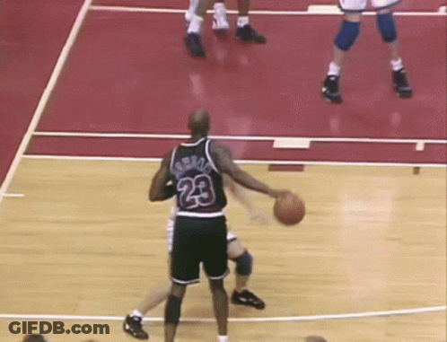 A Basketball Player With The Number 23 On His Jersey Dribbles The Ball GIF