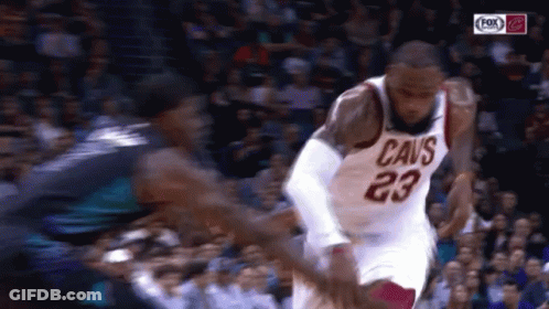 A Basketball Player With The Number 23 On His Jersey Is Dribbling A Ball GIF
