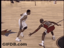 A Basketball Player With The Number 23 On His Jersey Is Dribbling The Ball GIF