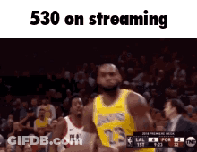 A Basketball Player With The Number 23 On His Jersey Is Jumping In The Air GIF