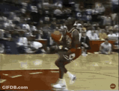 A Basketball Player With The Number 23 On His Jersey Is Jumping In The Air GIF