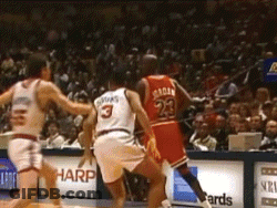 A Basketball Player With The Number 23 On His Jersey Is Playing Against Another Player . GIF