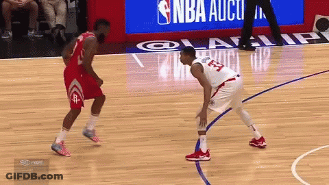 A Basketball Player With The Number 23 On His Jersey Is Standing On The Court GIF
