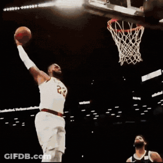 A Basketball Player With The Number 23 On His Jersey Jumps Into The Air GIF