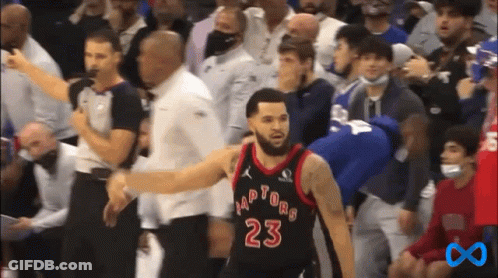 A Basketball Player With The Number 23 On His Jersey Stands In Front Of A Crowd Of People . GIF