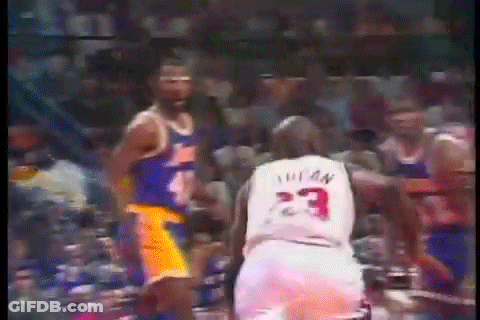 A Basketball Player With The Number 23 On His Jersey Stands Next To Another Player . GIF