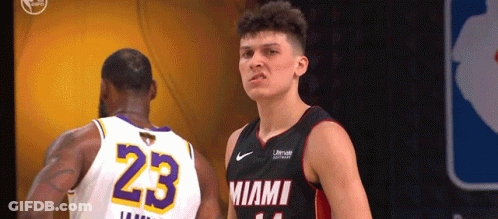A Basketball Player With The Number 23 On His Jersey Stands Next To Another Player GIF