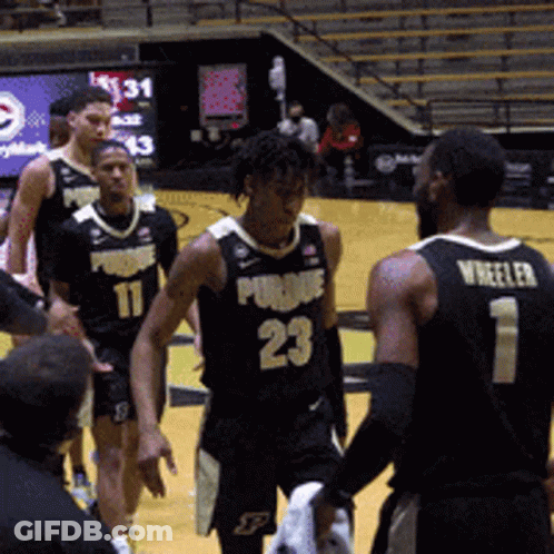 A Basketball Player With The Number 23 On His Jersey Talks To Another Player GIF