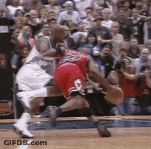 A Basketball Player With The Number 23 On His Shorts Is Being Fouled GIF