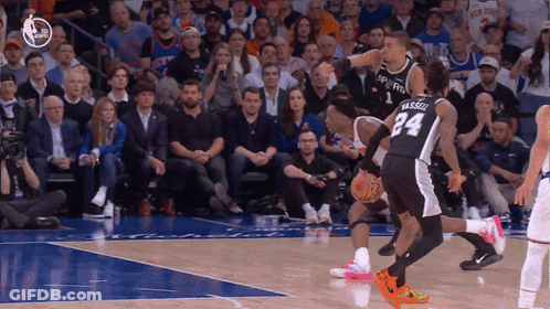 A Basketball Player With The Number 24 On His Back Dribbles The Ball GIF