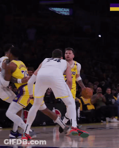 A Basketball Player With The Number 24 On His Back Dribbles The Ball GIF