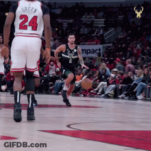 A Basketball Player With The Number 24 On His Jersey Dribbles The Ball GIF