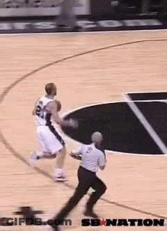 A Basketball Player With The Number 24 On His Jersey Dribbles The Ball GIF