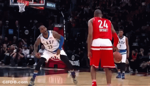 A Basketball Player With The Number 24 On His Jersey Stands Next To Another Player GIF