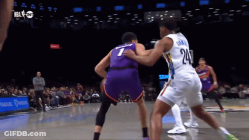 A Basketball Player With The Number 24 On His Jersey Tries To Block Another Player GIF