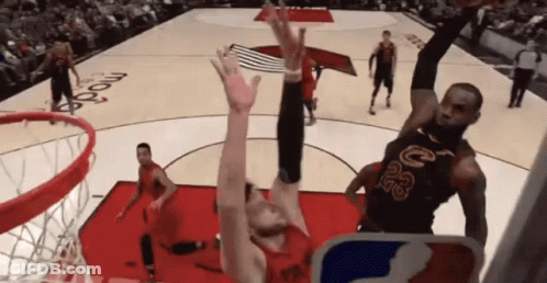A Basketball Player With The Number 25 On His Jersey Goes Up For A Dunk GIF