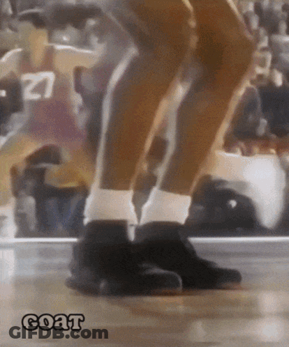 A Basketball Player With The Number 27 On His Jersey Is Jumping On The Court GIF