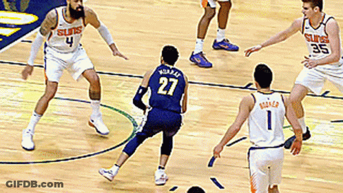 A Basketball Player With The Number 27 On His Jersey Is Playing Defense GIF