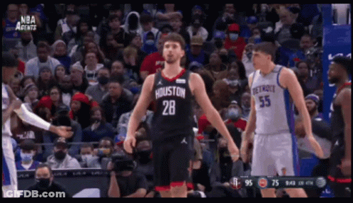 A Basketball Player With The Number 28 On His Jersey Stands In Front Of A Crowd GIF