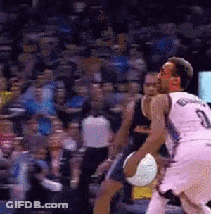 A Basketball Player With The Number 3 On His Jersey Is Dribbling A Basketball GIF