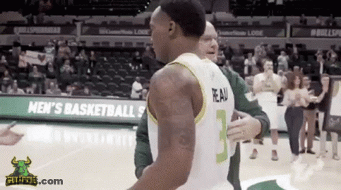 A Basketball Player With The Number 3 On His Jersey Is Hugging Another Player GIF