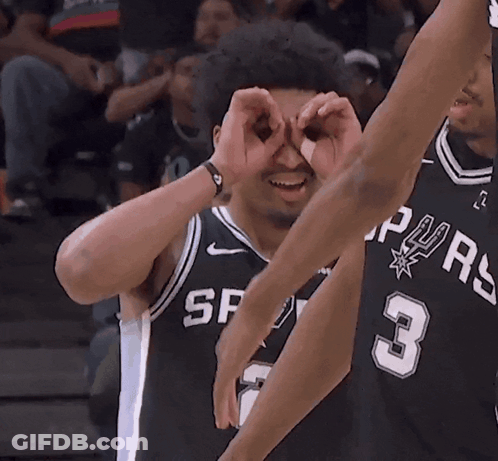 A Basketball Player With The Number 3 On His Jersey Looks Through His Hands GIF