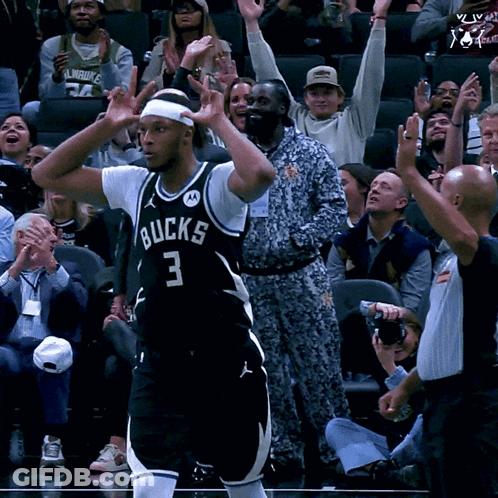 A Basketball Player With The Number 3 On His Jersey Stands In Front Of A Crowd GIF