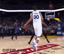 A Basketball Player With The Number 30 On His Back Dribbles The Ball GIF