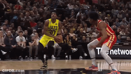 A Basketball Player With The Number 30 On His Jersey Dribbles The Ball GIF
