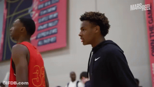A Basketball Player With The Number 31 On His Jersey Stands Next To Another Player GIF
