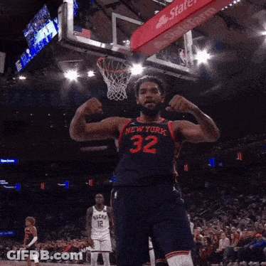 A Basketball Player With The Number 32 On His Jersey Flexes His Muscles GIF