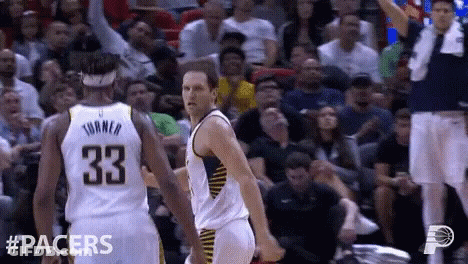A Basketball Player With The Number 33 On His Back Is Talking To Another Player GIF