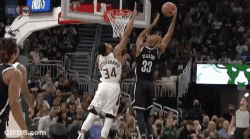 A Basketball Player With The Number 33 On His Jersey Goes Up For A Shot GIF