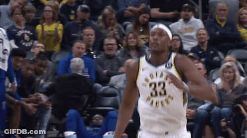 A Basketball Player With The Number 33 On His Jersey Is Standing In Front Of A Crowd GIF