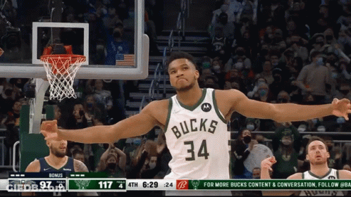 A Basketball Player With The Number 34 On His Jersey Is Celebrating GIF