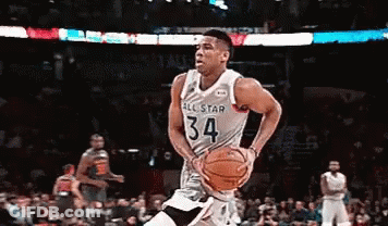 A Basketball Player With The Number 34 On His Jersey Is Dribbling The Ball GIF
