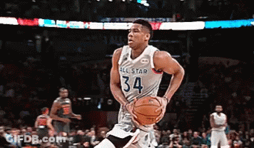 A Basketball Player With The Number 34 On His Jersey Is Dribbling The Ball GIF