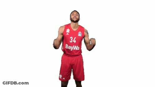 A Basketball Player With The Number 34 On His Jersey Is Flexing His Muscles GIF