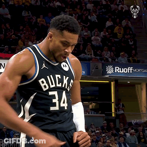 A Basketball Player With The Number 34 On His Jersey Stands In Front Of A Crowd GIF