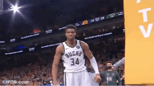 A Basketball Player With The Number 34 On His Jersey Stands In Front Of A Crowd . GIF