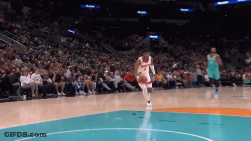 A Basketball Player With The Number 4 On His Jersey Is Dribbling The Ball GIF