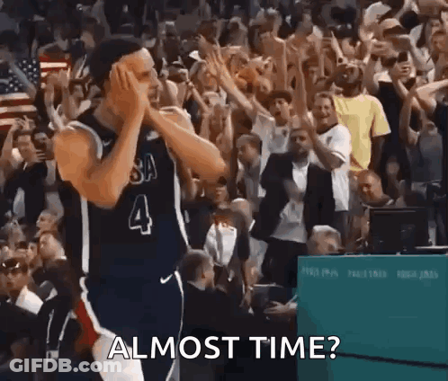 A Basketball Player With The Number 4 On His Jersey Is Standing In Front Of A Crowd Of People And Applauding . GIF