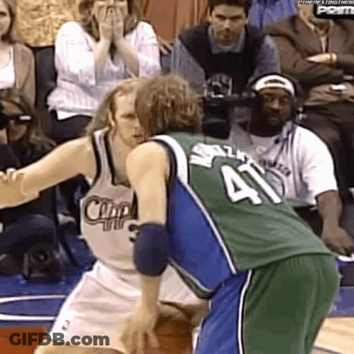 A Basketball Player With The Number 41 On His Jersey Is Being Blocked By Another Player GIF