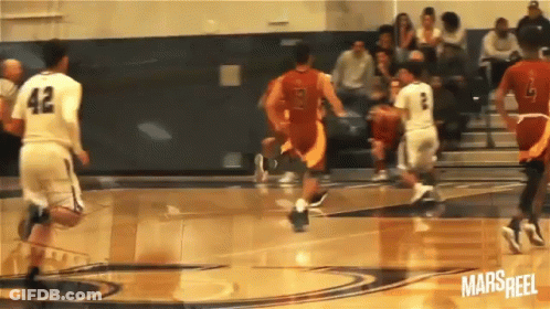 A Basketball Player With The Number 42 On His Jersey Is Dribbling The Ball GIF