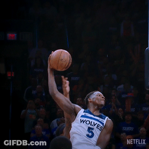 A Basketball Player With The Number 5 On His Jersey Is Dunking The Ball GIF