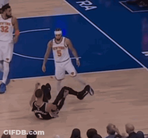 A Basketball Player With The Number 5 On His Jersey Is Sitting On The Floor GIF