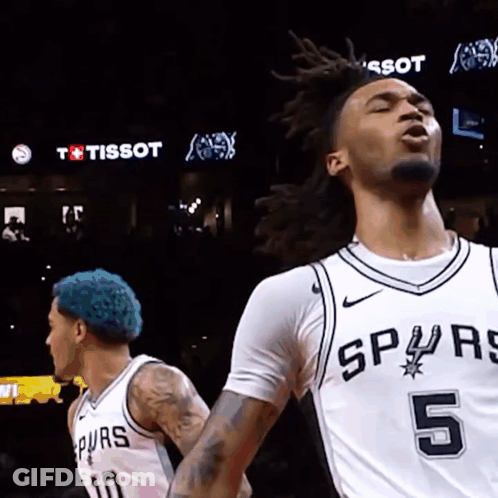 A Basketball Player With The Number 5 On His Jersey Is Standing Next To Another Player GIF